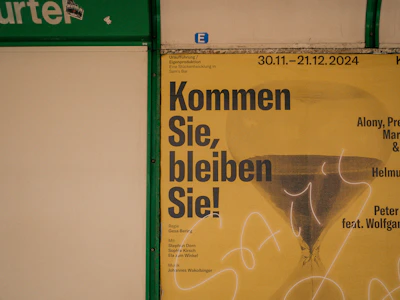 A poster on a wall with writing on it