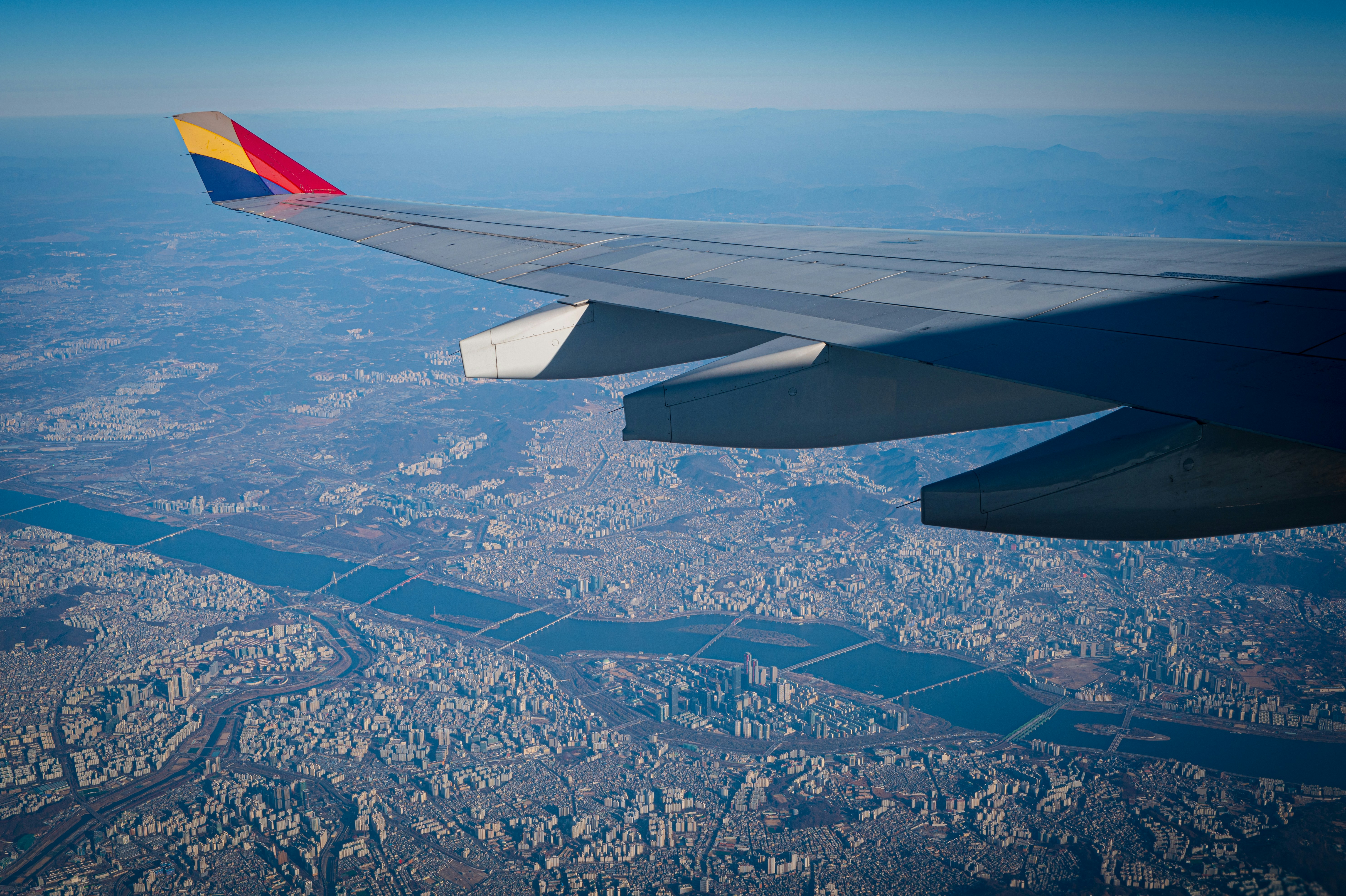 The wing of an airplane flying over a city, 