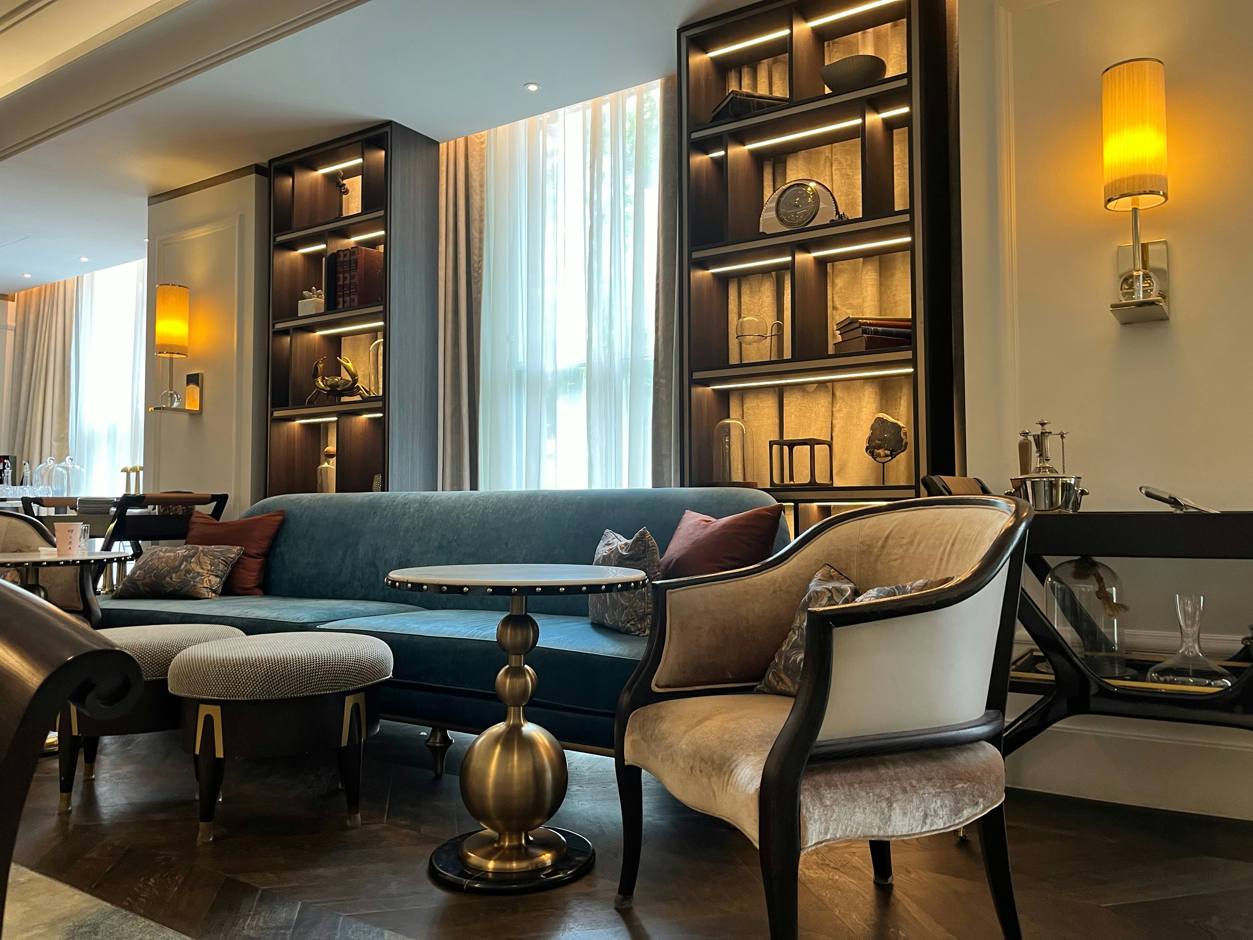 Luxurious ARZERA consultation space with elegant curtains and designer furniture in warm ambient lighting