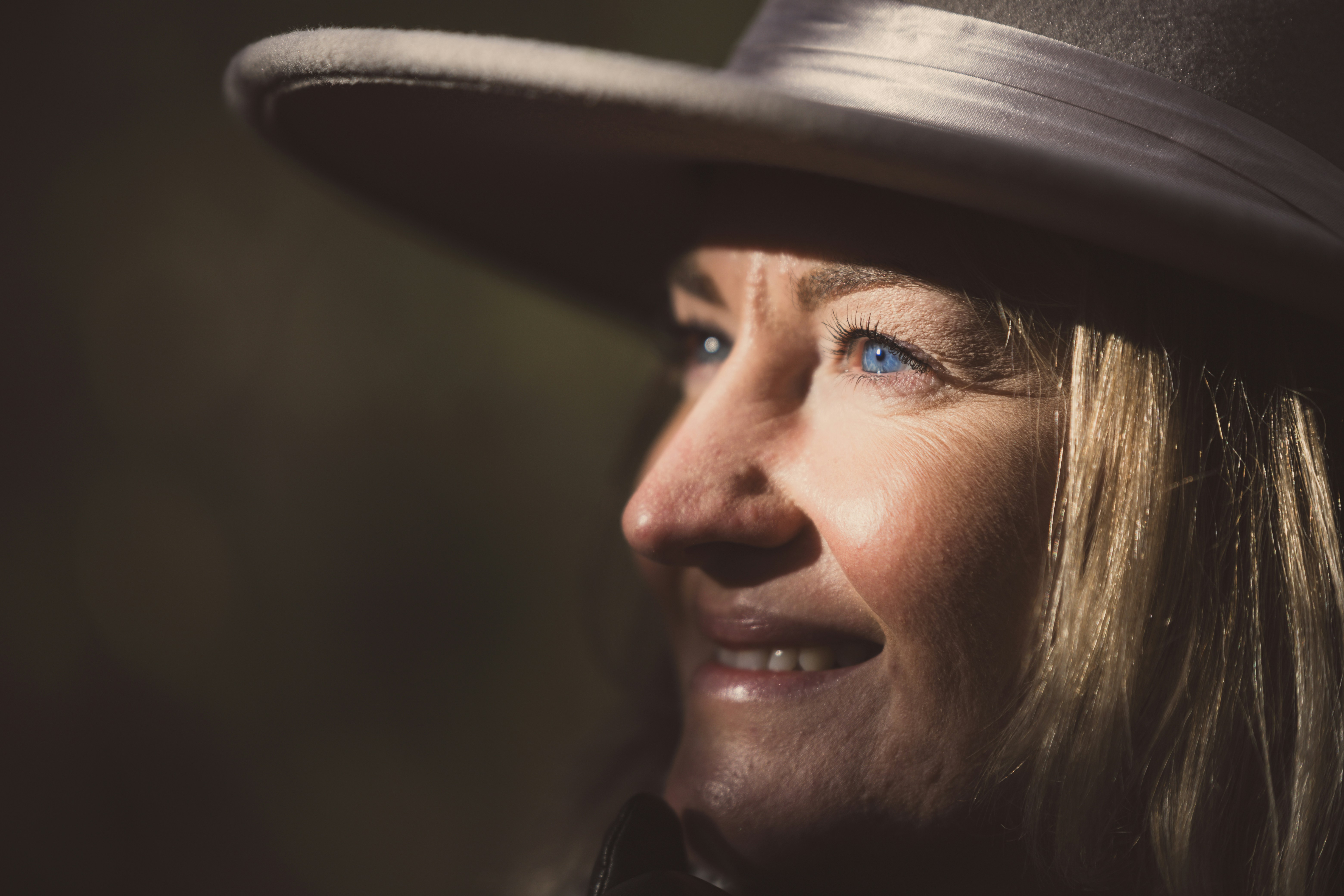 A woman wearing a black hat and a black jacket