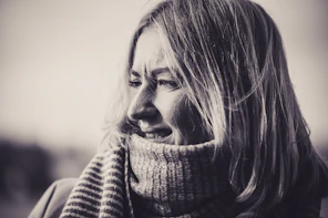 A black and white photo of a woman wearing a scarf
