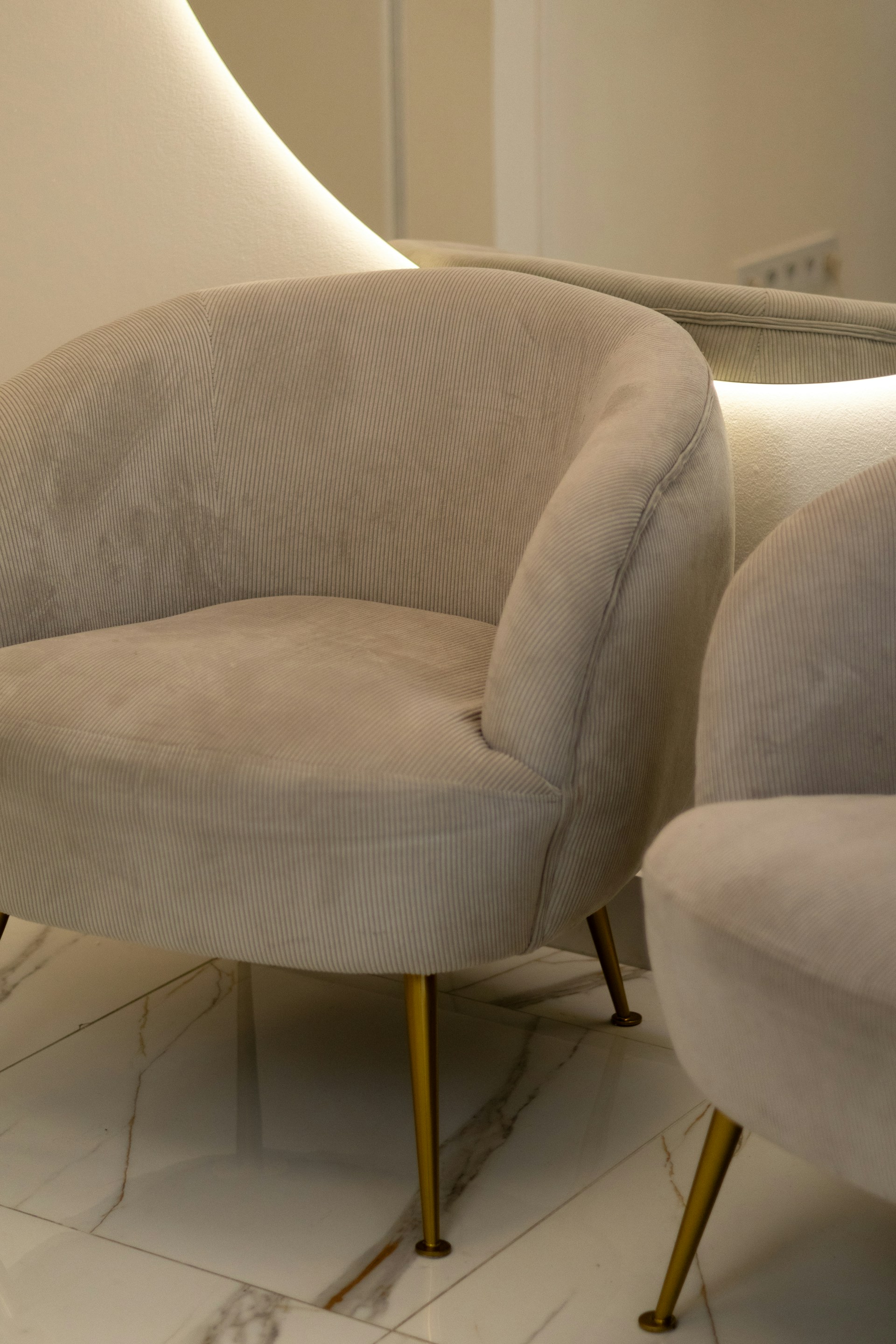 A chair and a foot stool in a room
