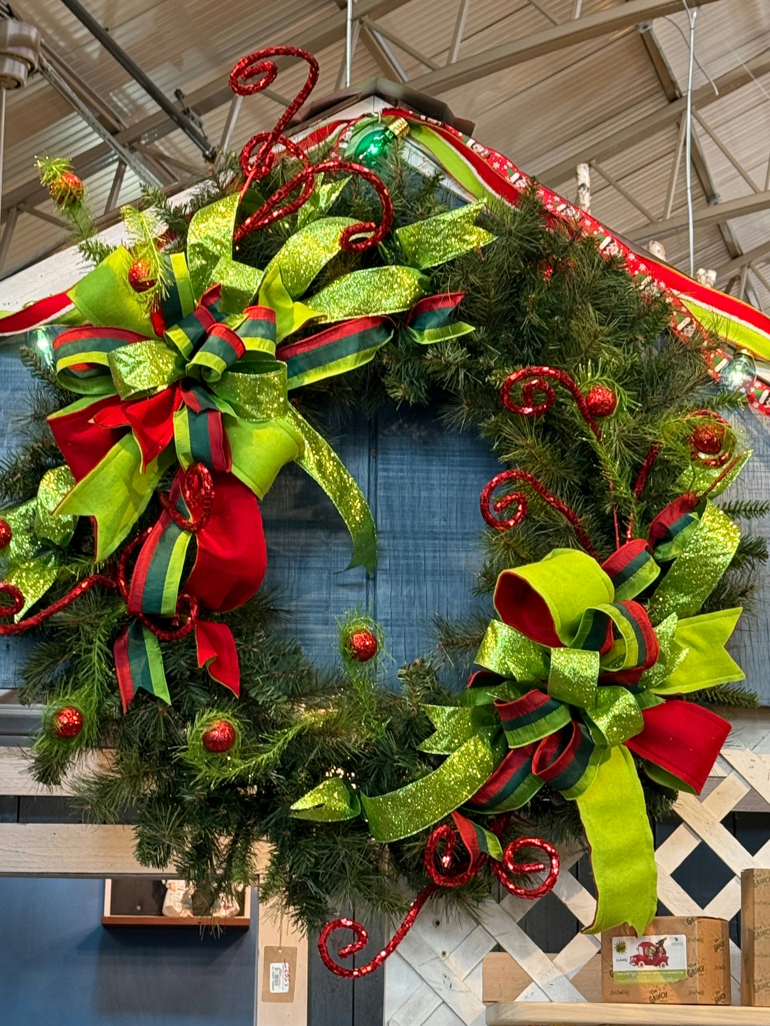 A christmas wreath hanging from the ceiling of a building