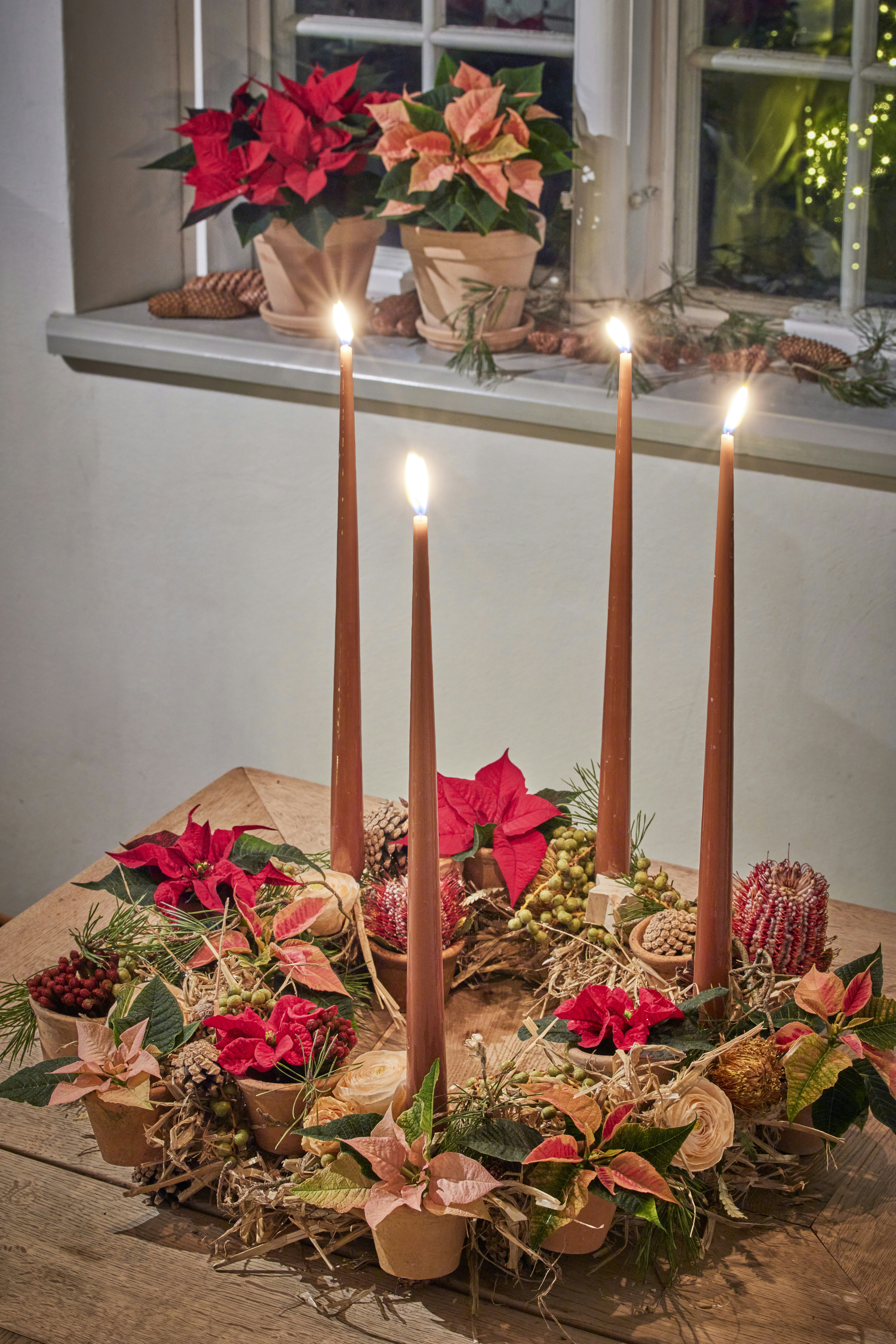 A wooden table topped with candles and flowers