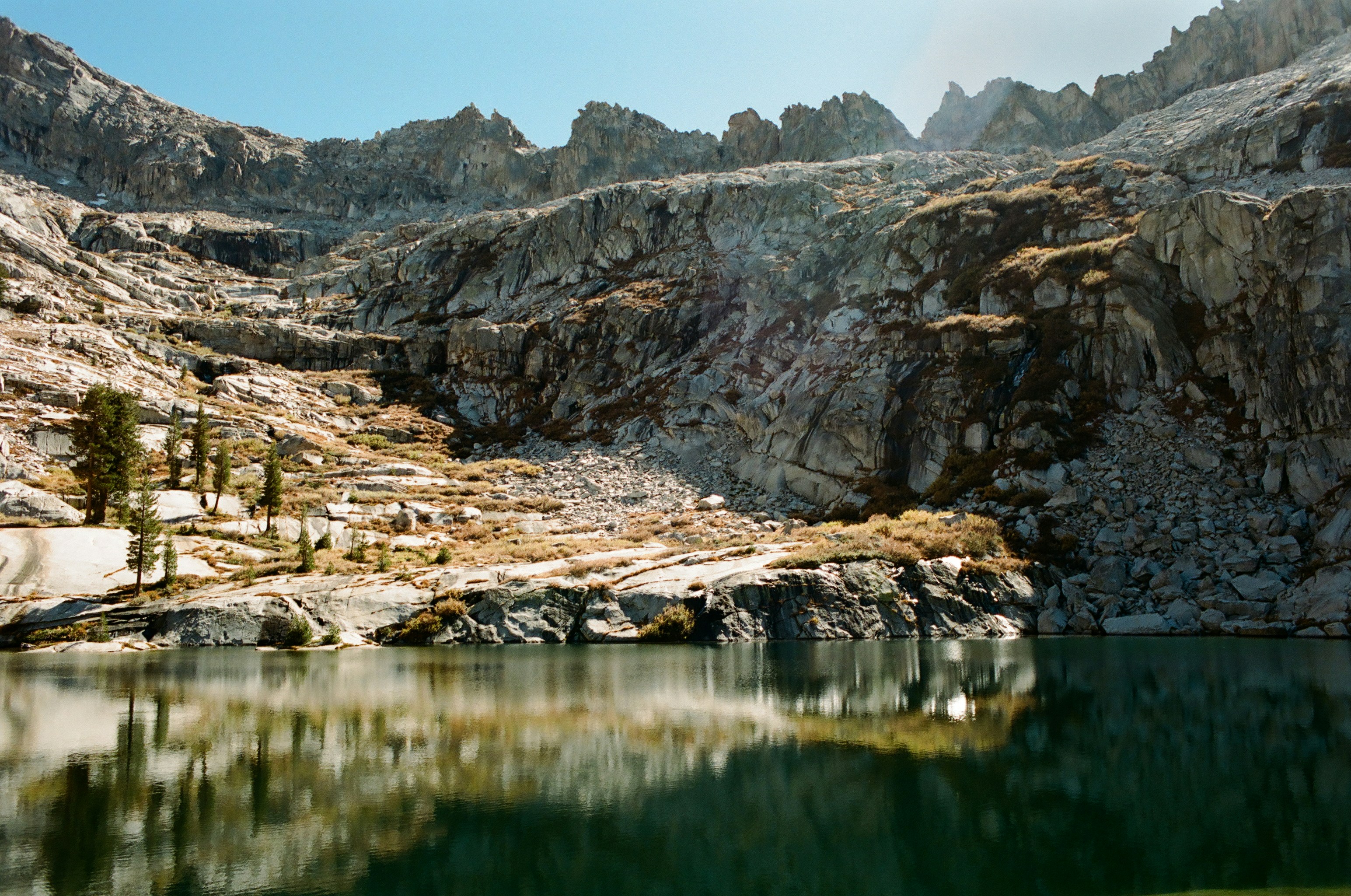 A mountain range with a lake in the foreground