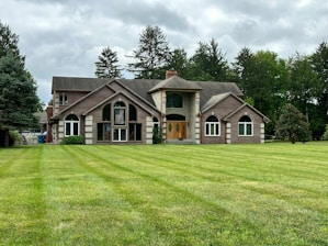 A large house sitting on top of a lush green field