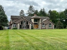 A large house sitting on top of a lush green field