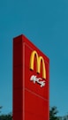 A mcdonald's sign is shown against a blue sky