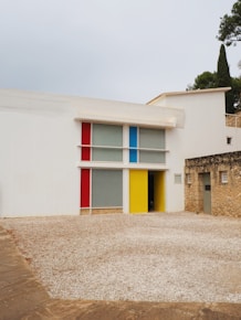 A large white building with a colorful door