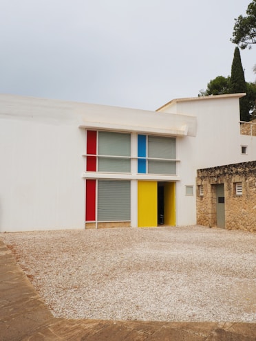 A large white building with a colorful door