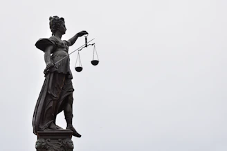 A statue of lady justice holding a scale of justice