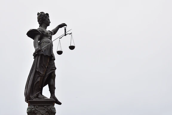 A statue of lady justice holding a scale of justice