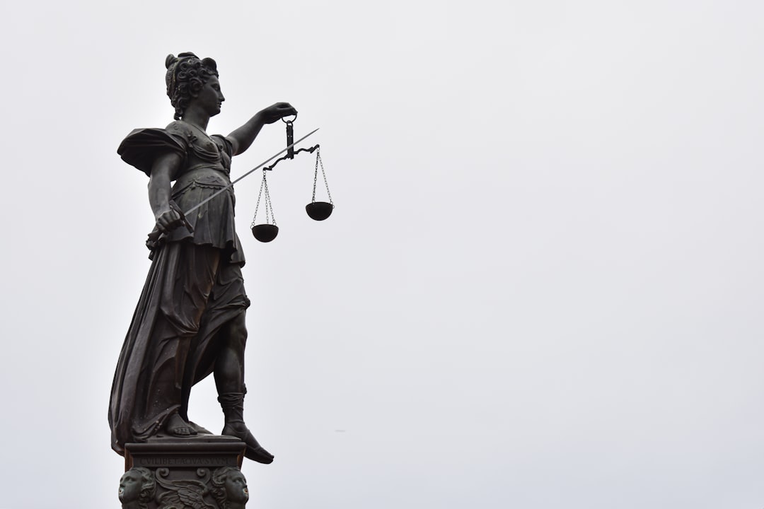 A statue of lady justice holding a scale of justice,