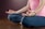 A woman in a pink shirt is doing yoga