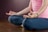 A woman in a pink shirt is doing yoga