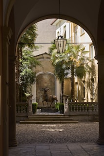 An archway leading to a courtyard with a fountain