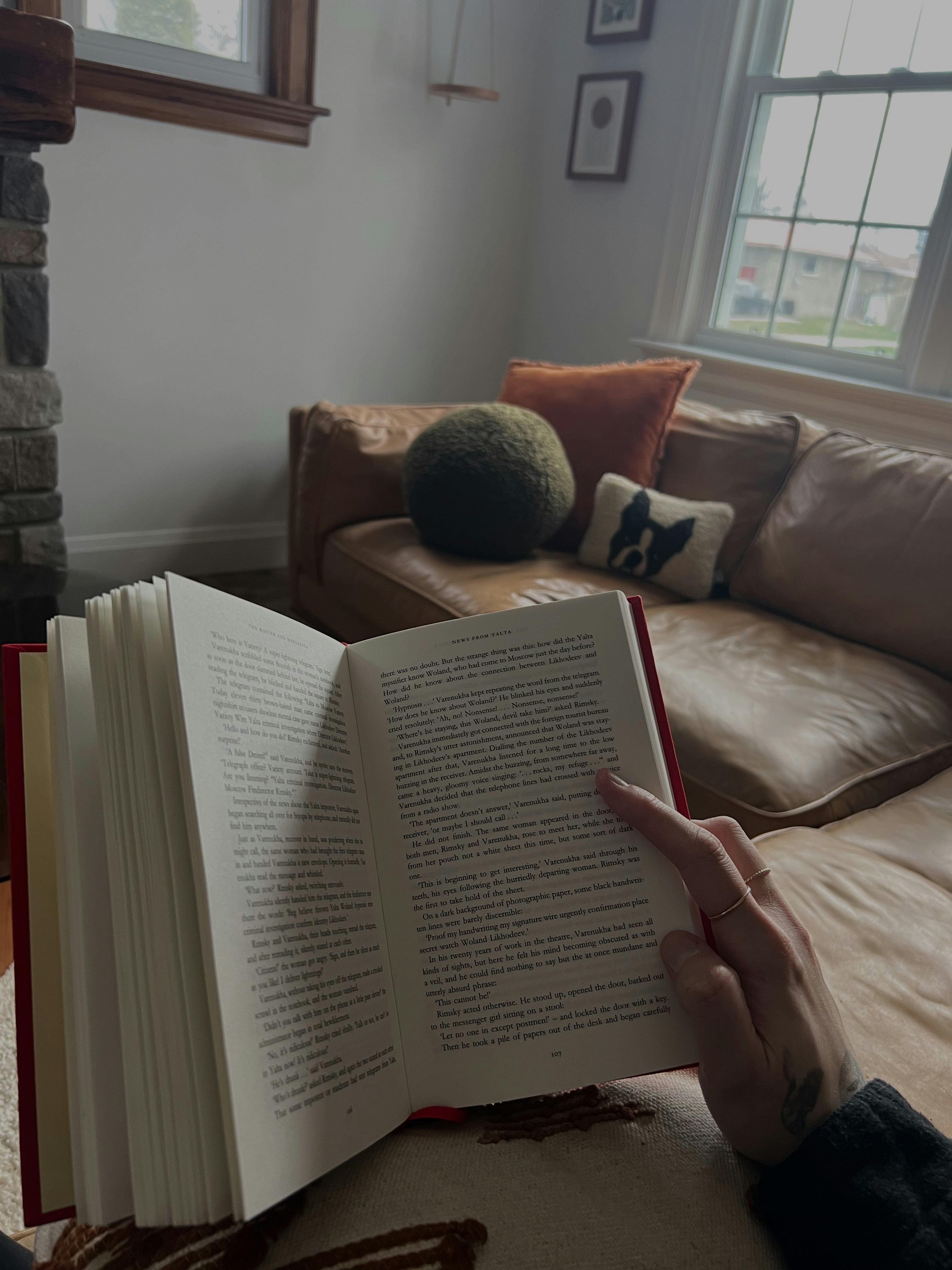 A person sitting on a couch reading a book