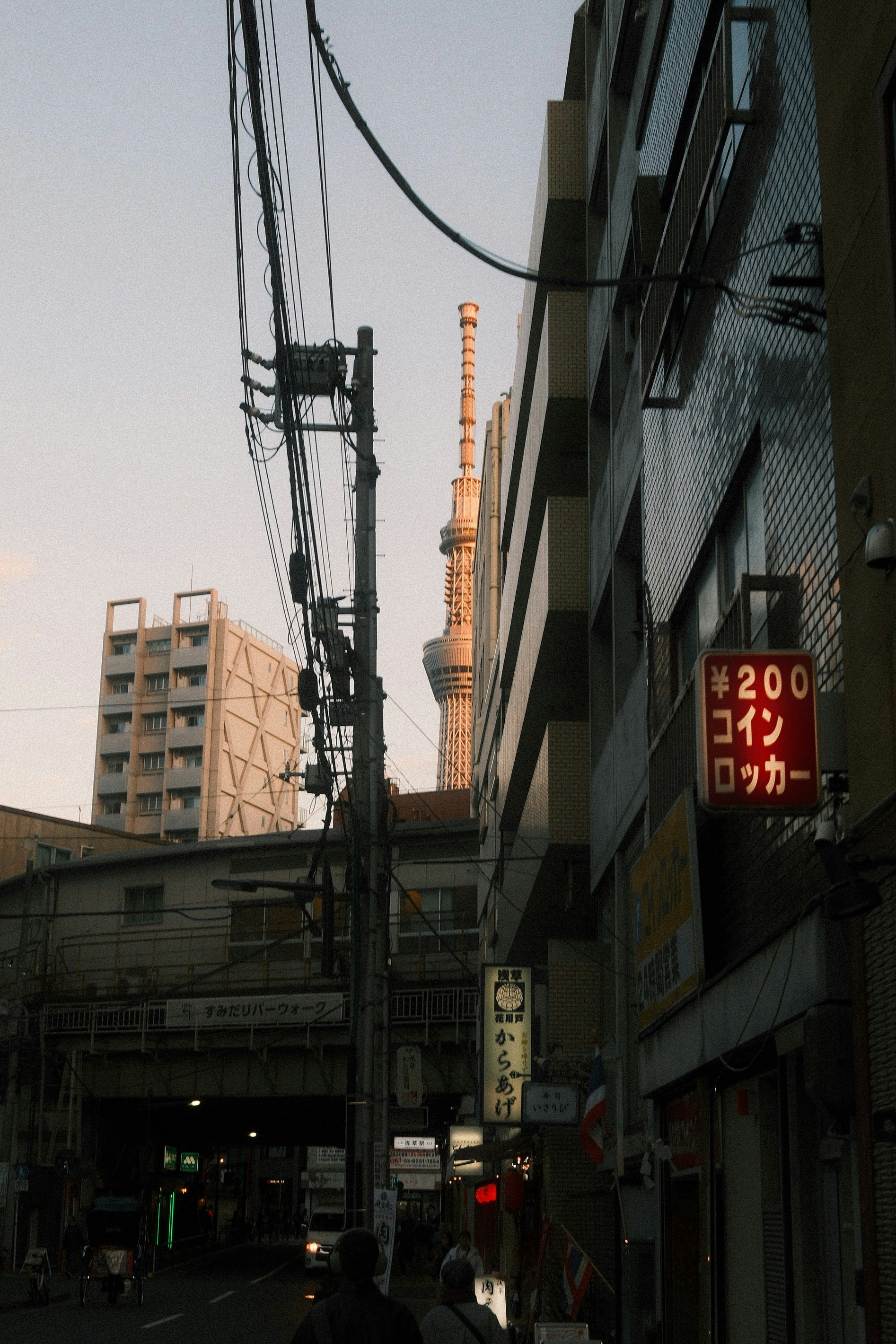 A person walking down a street next to tall buildings