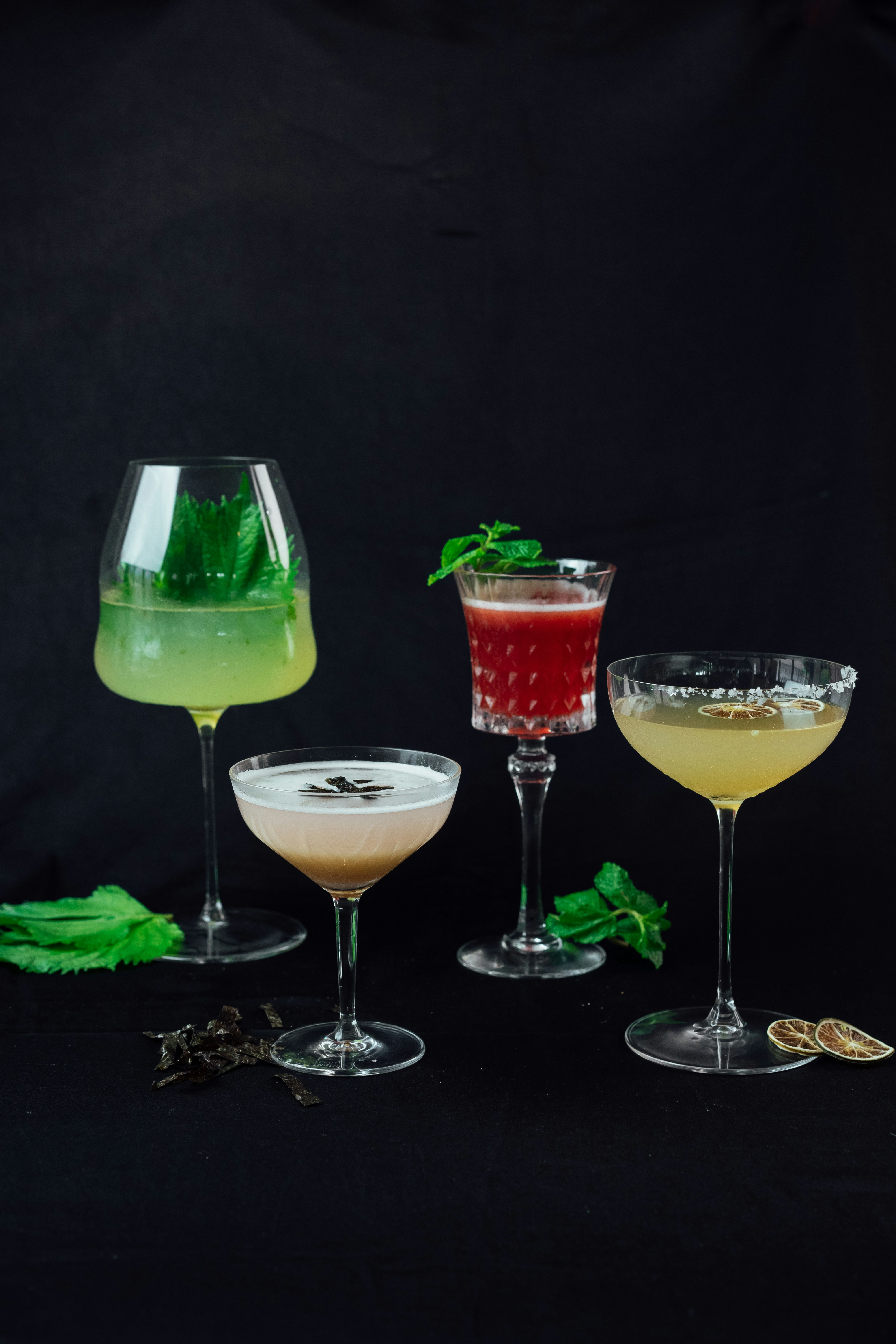Un groupe de quatre verres remplis de différents types de boissons