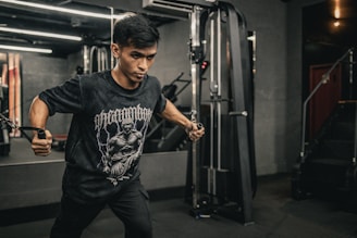 A man in a gym holding a bar