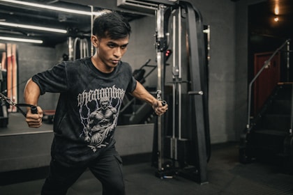 A man in a gym holding a bar