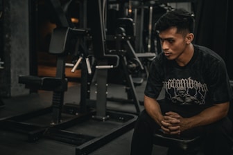 A man sitting on a bench in a gym
