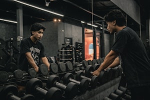 A couple of men working out in a gym