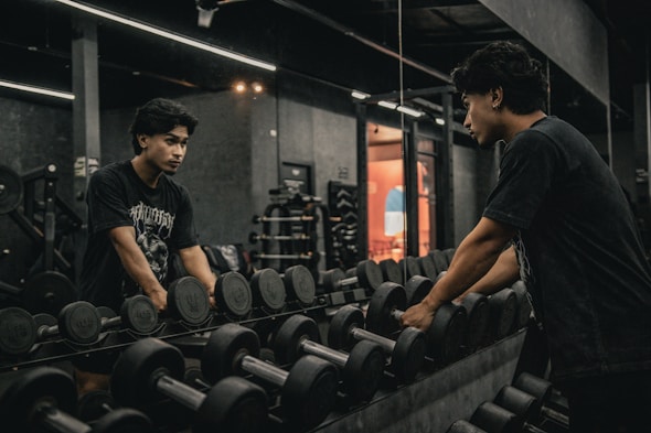 A couple of men working out in a gym