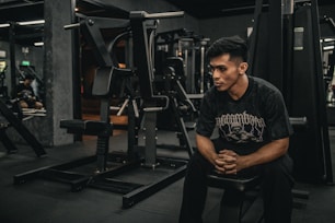 A man sitting on a bench in a gym