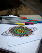 A picture of a coloring book with markers and pencils