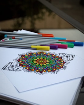 A picture of a coloring book with markers and pencils
