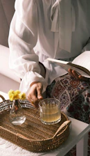 A person sitting at a table with a basket of flowers