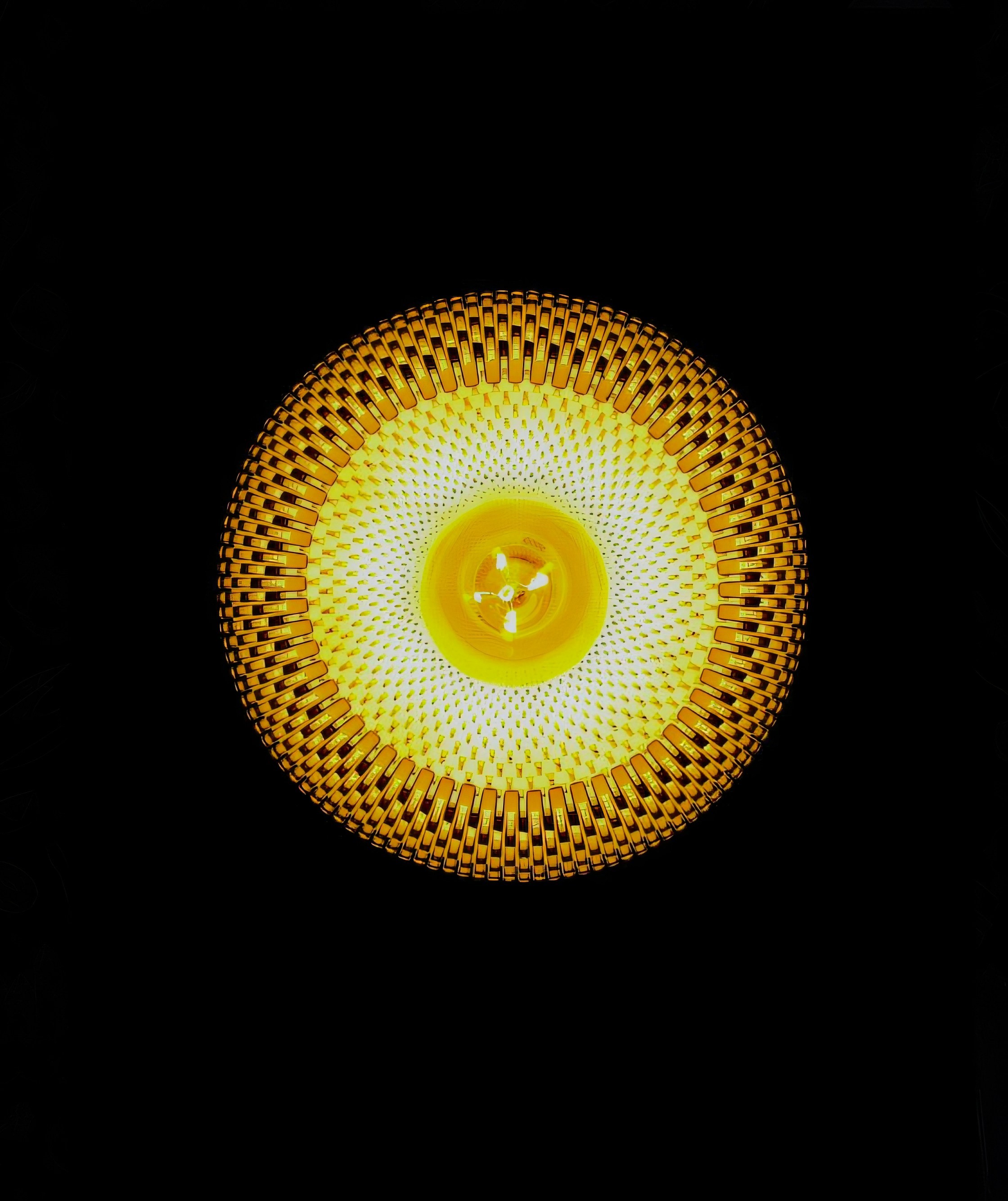 A close up of a yellow object on a black background