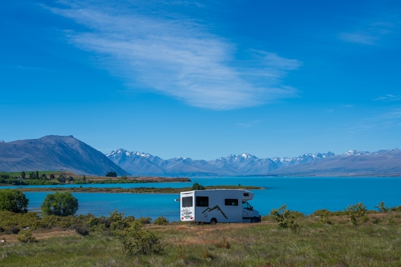 An rv parked on the side of a lake