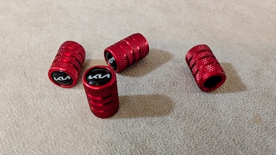A group of red grips sitting on top of a carpet