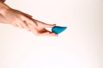 A person holding a blue object in their hand