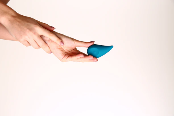 A person holding a blue object in their hand