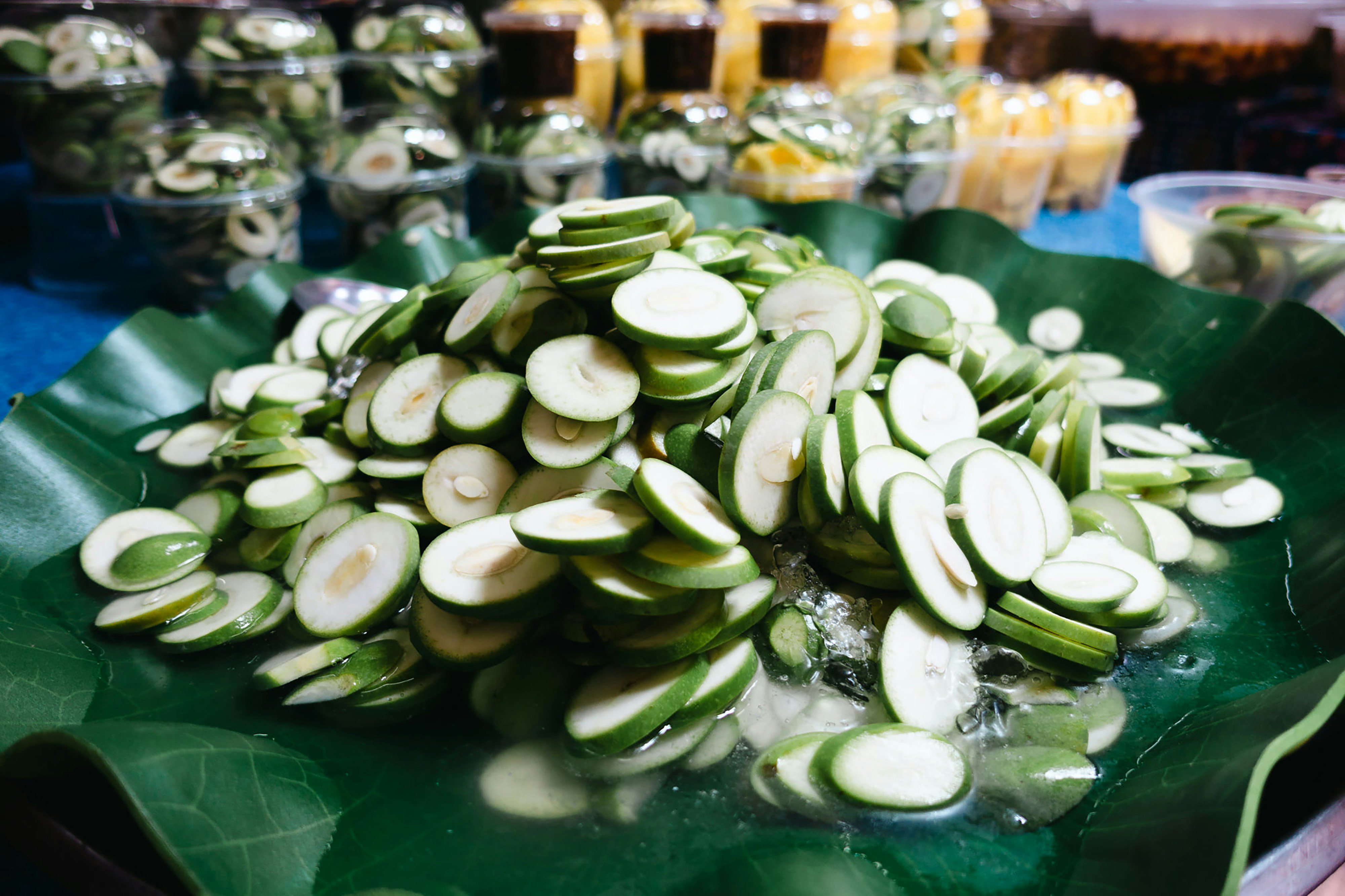 Sliced cucumber on banana leaves