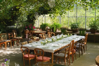 A dining room with a large table and chairs