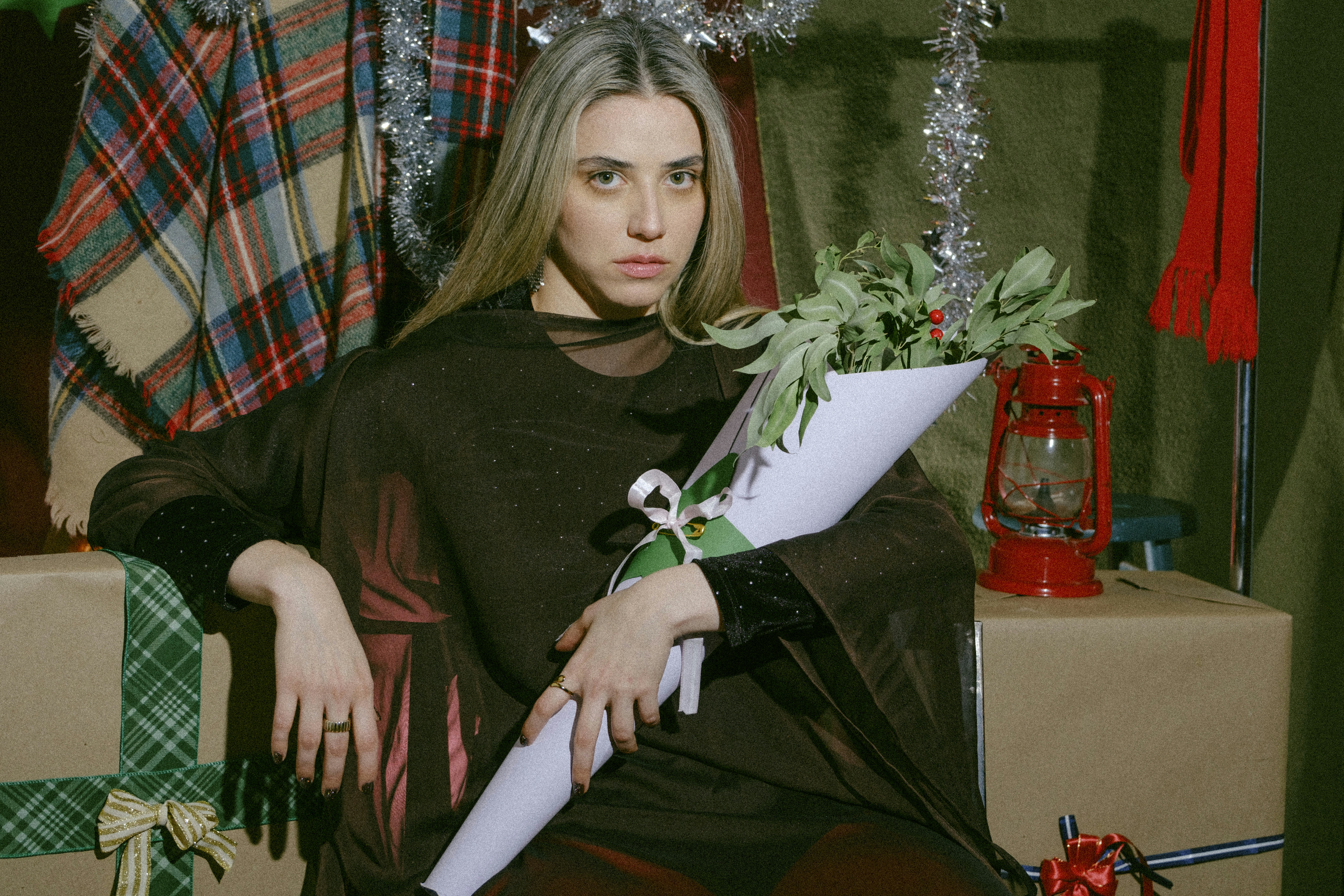 A woman sitting in a chair holding a bouquet of flowers