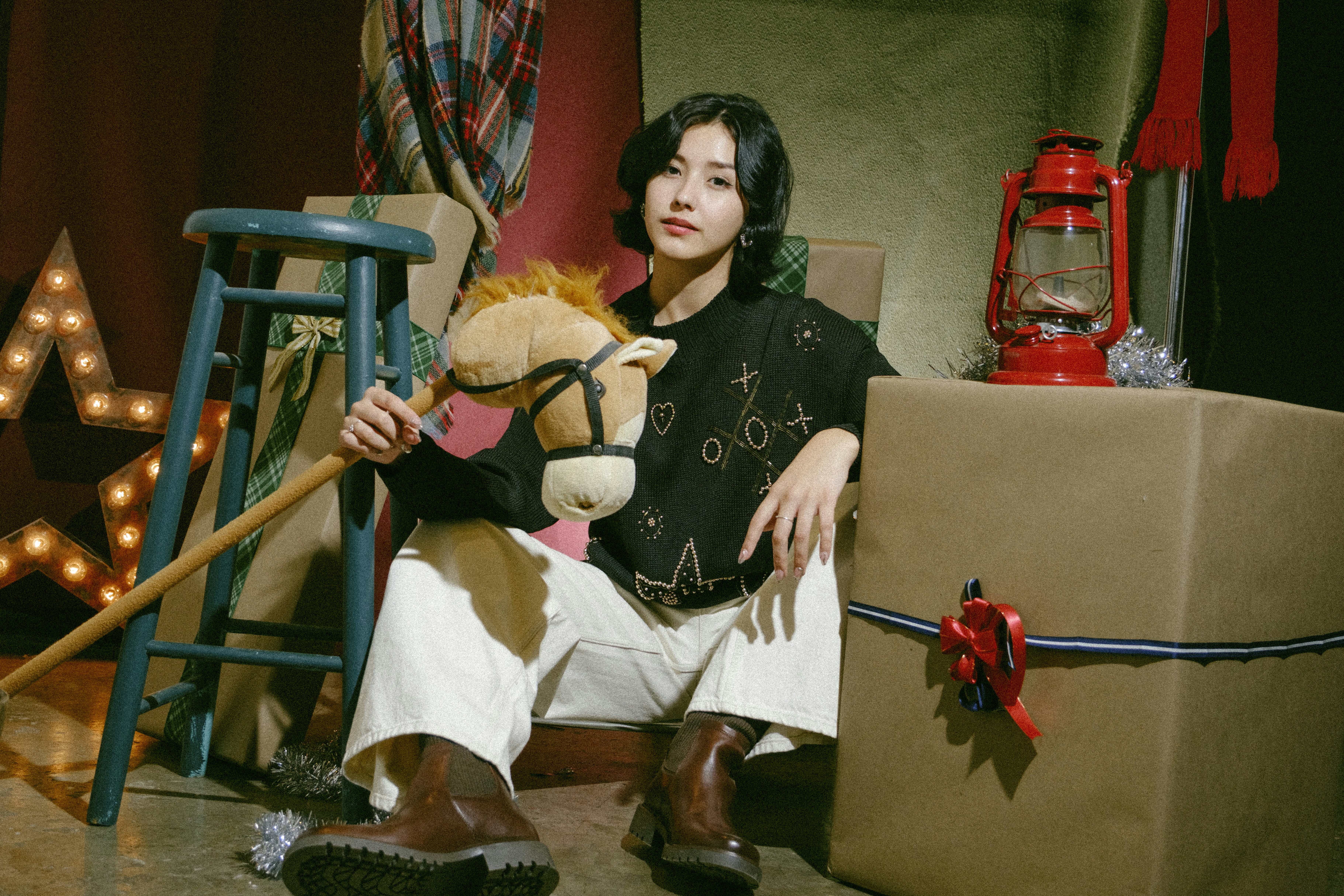 A woman sitting on a chair holding a stuffed animal