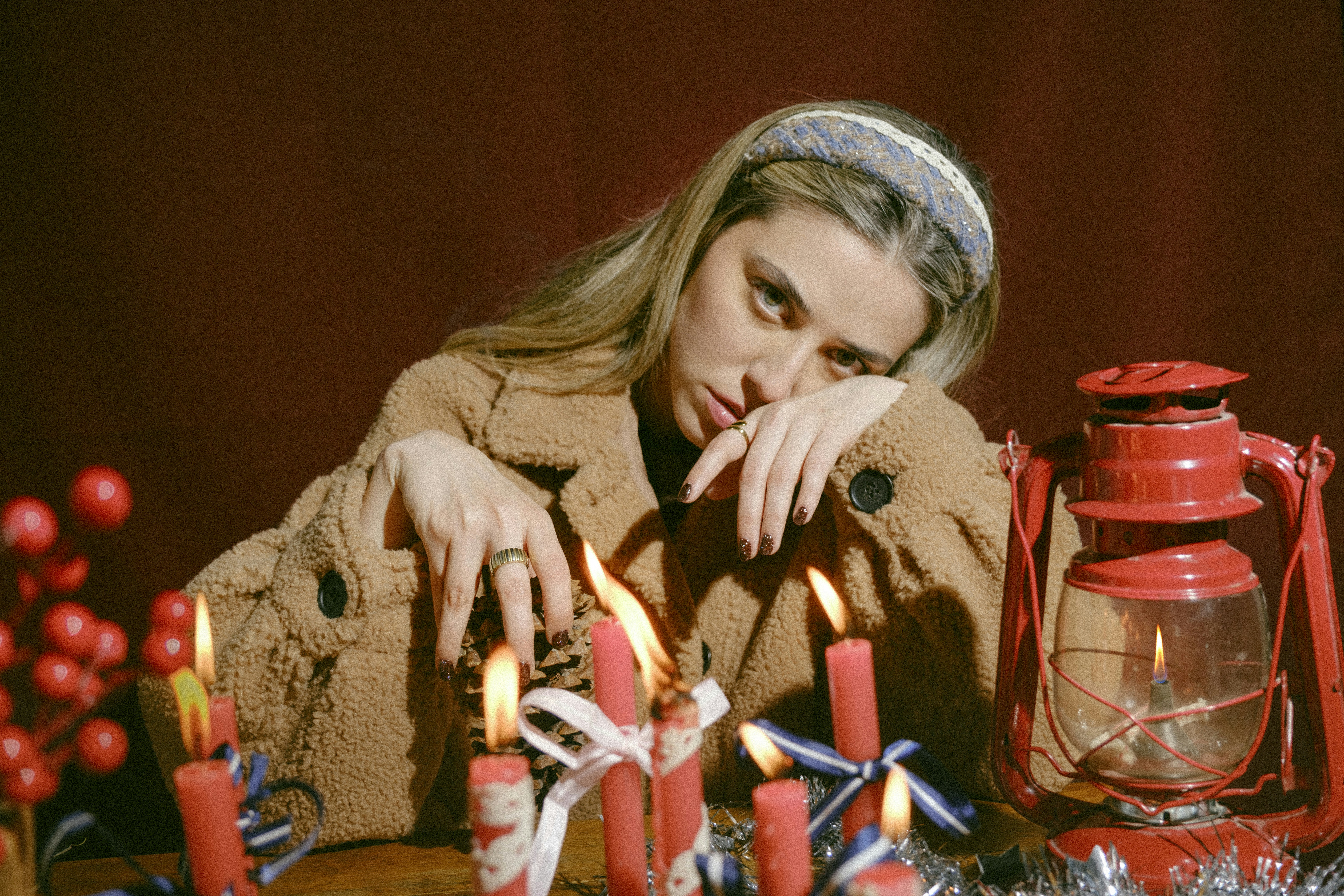 A woman sitting in front of a table with candles