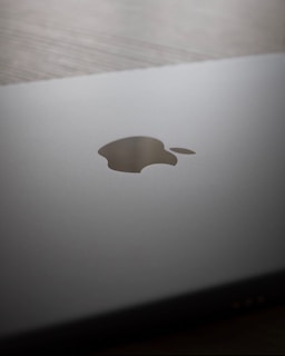 A close up of an apple laptop on a table