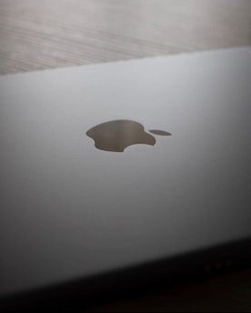 A close up of an apple laptop on a table