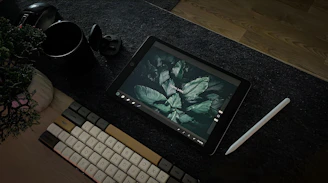 A computer monitor sitting on top of a desk next to a keyboard