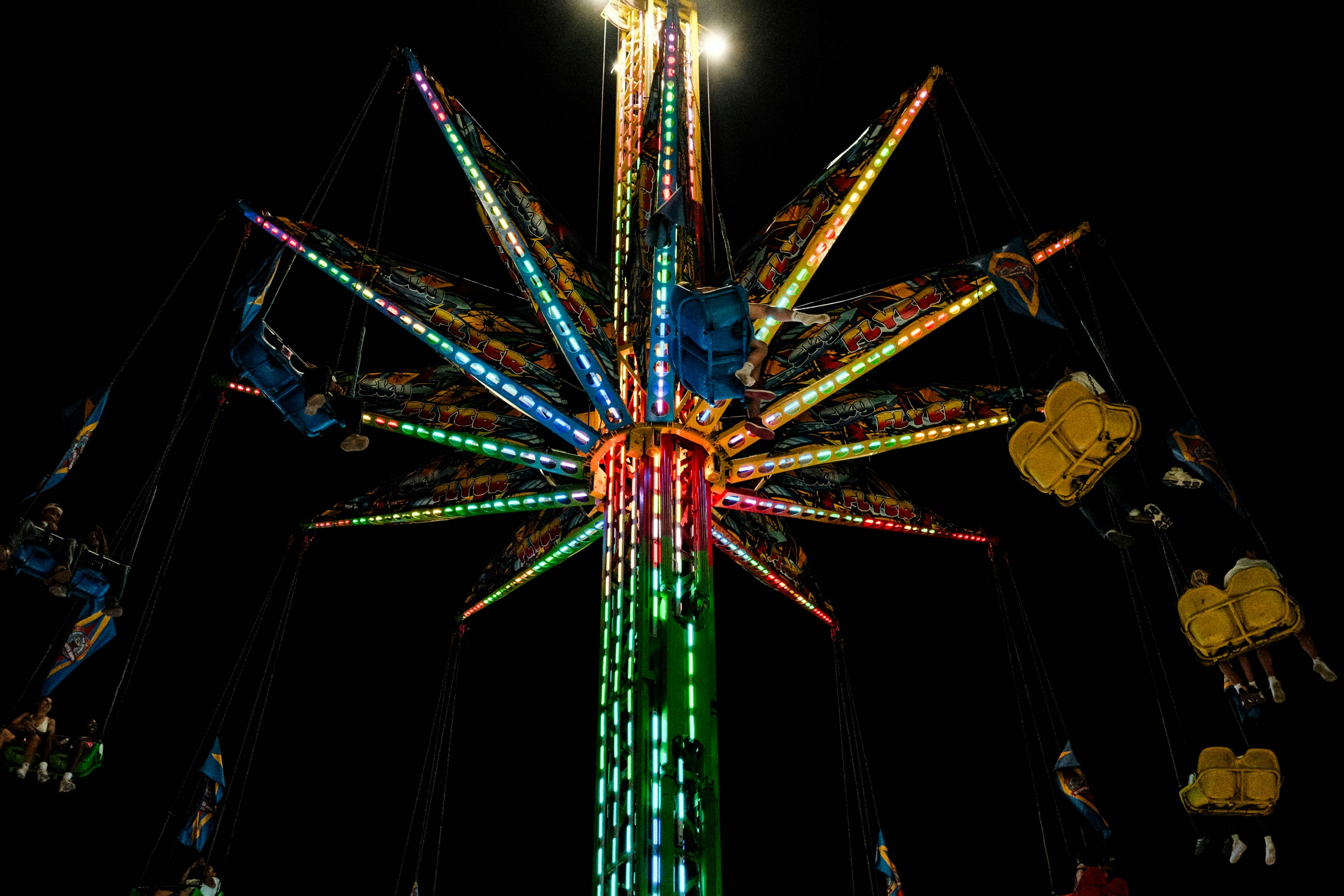 A merry go round ride lit up at night