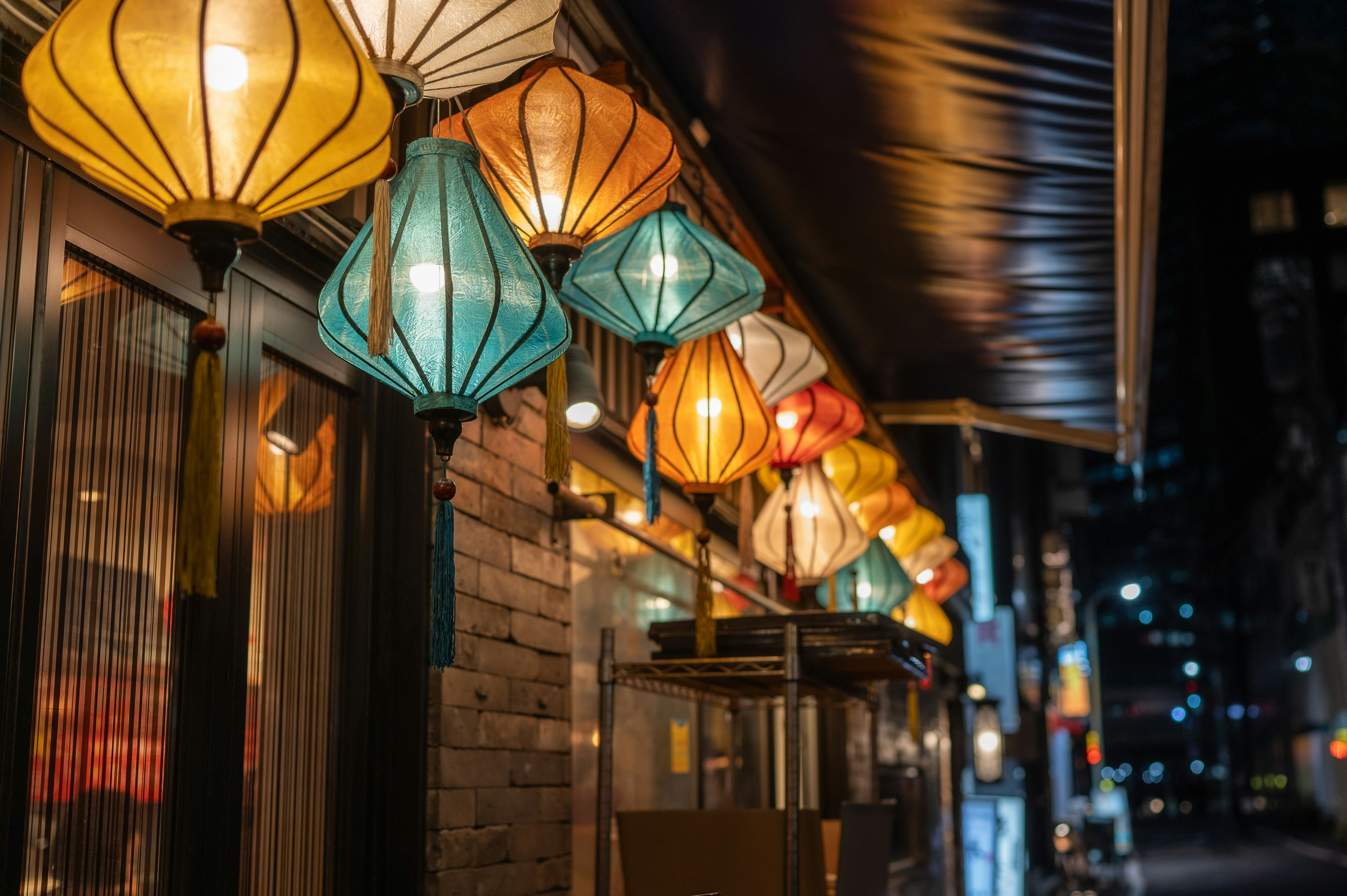 A row of lights hanging from the side of a building