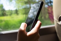 A person holding a cell phone in their hand