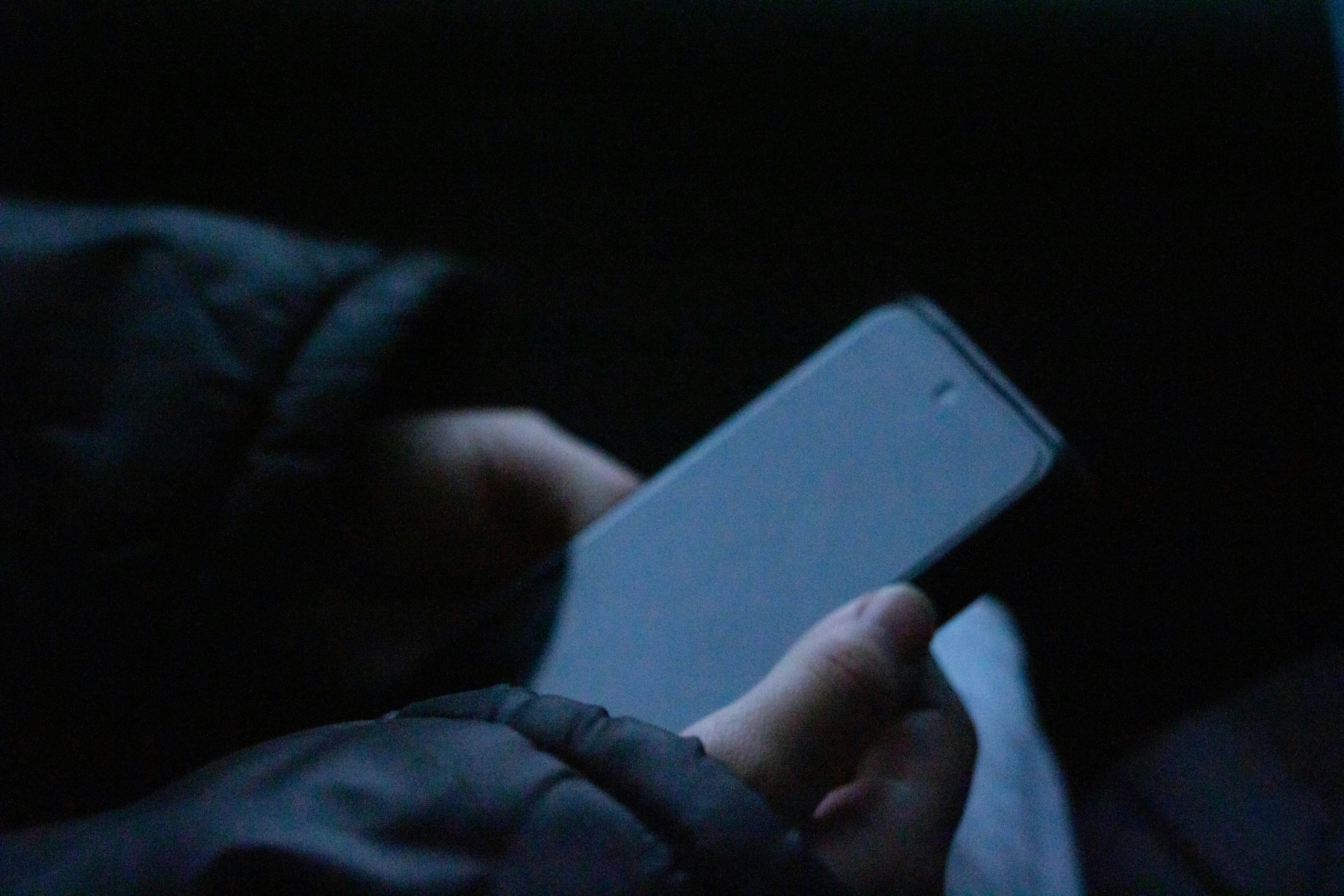 A person holding a cell phone in their hand