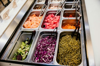 A salad bar with a variety of salads in trays